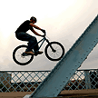 Mike riding on his front wheel.